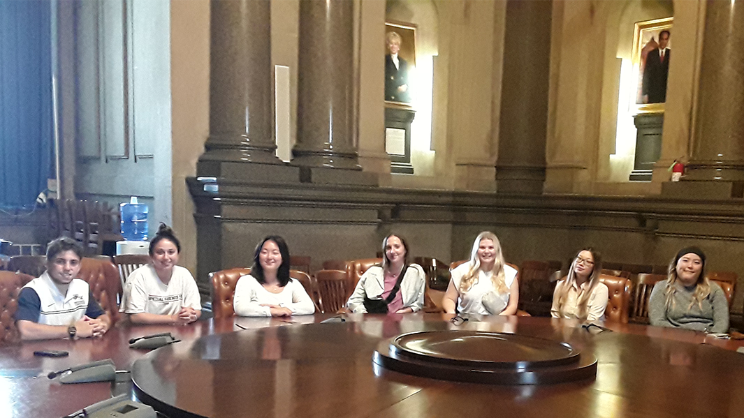 Seven HSAD students sit around large table in Philadelphia City Council Caucus room